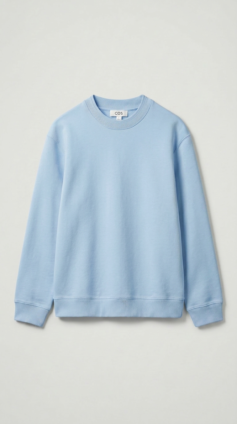 powder blue crewneck sweater laid flat on a pale studio surface